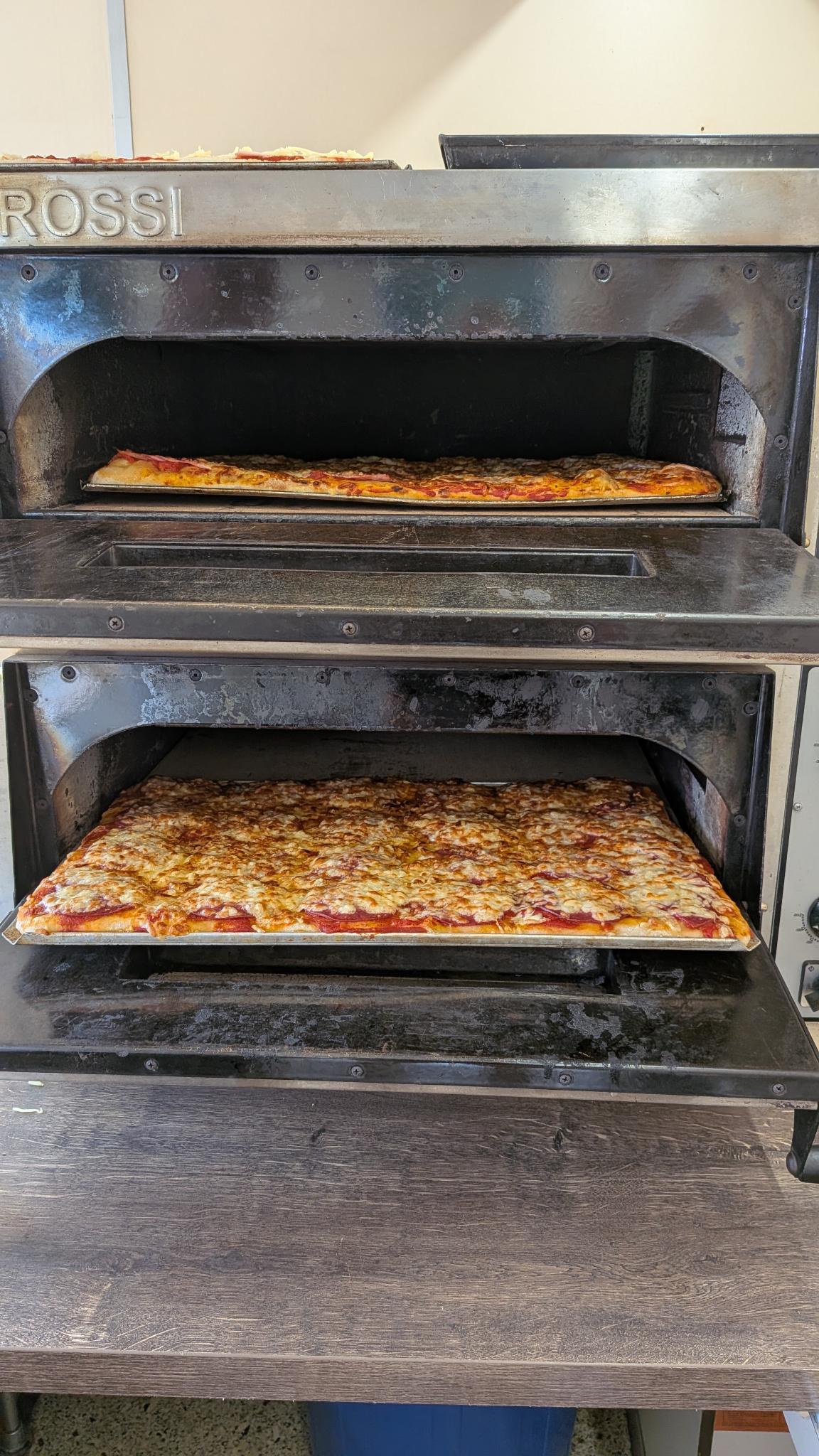 Frisch gebackene Blechpizza im Pizzaofen